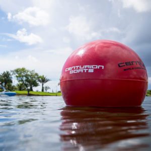 A red ball floating in a body of water, mesmerizing surfers and fans with its dynamic presence.