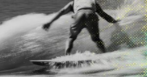 A man Wake surfing on a surfboard.