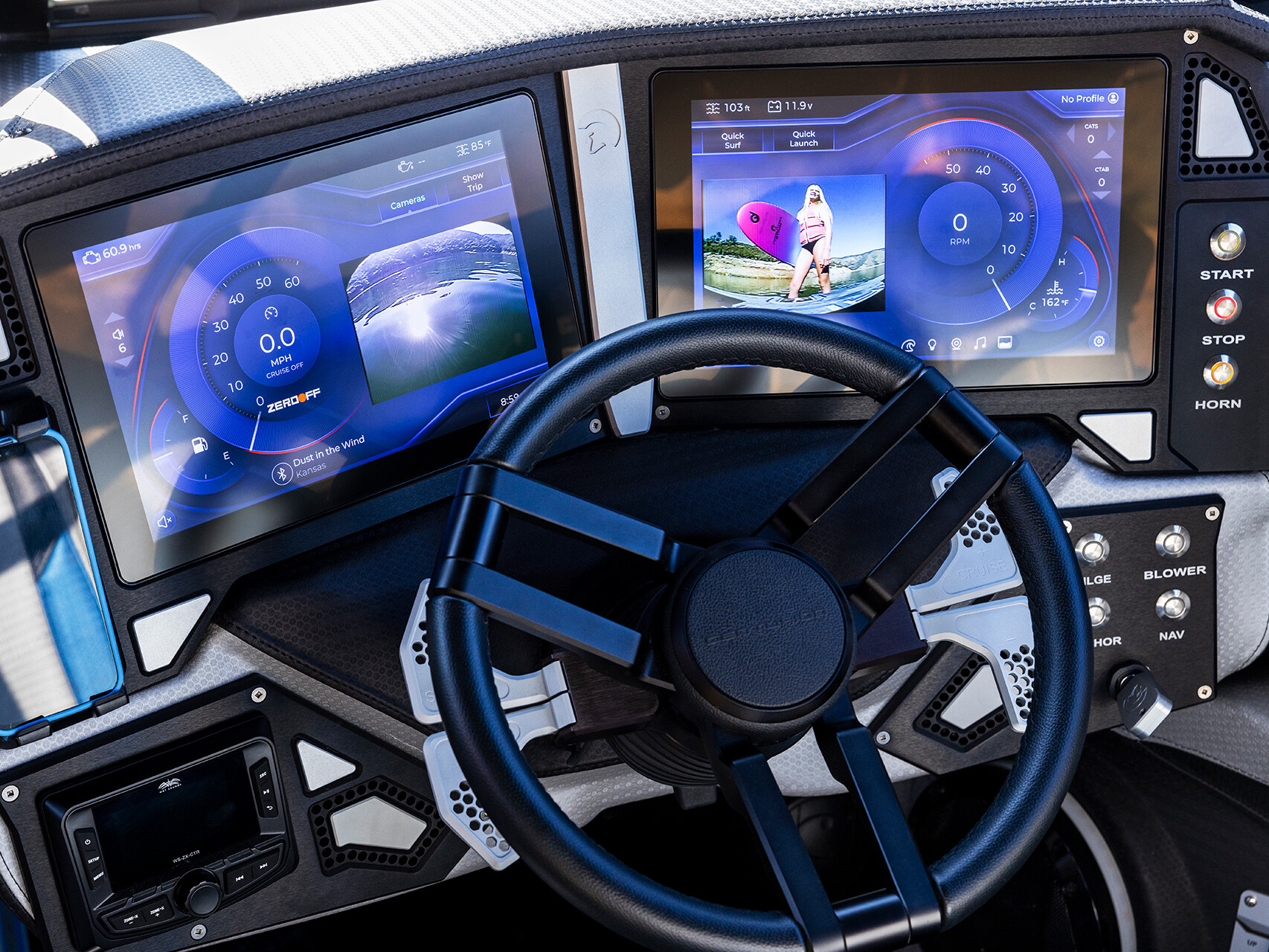 Close-up of a modern vehicle dashboard from The Centurion Ri Series, featuring two digital touchscreens displaying navigation and media controls above the steering wheel.