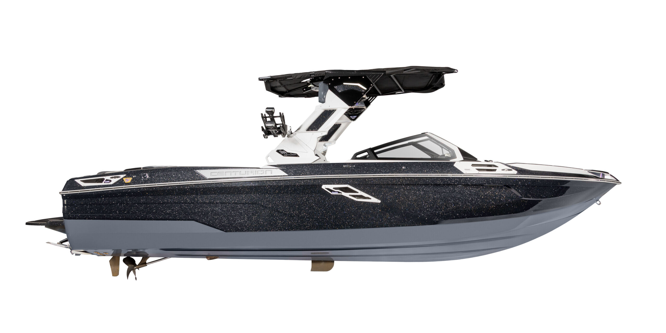 Side view of a dark blue and white motorboat from The Centurion Ri Series, featuring a wakeboard tower and tinted windshield, set against a plain white background.