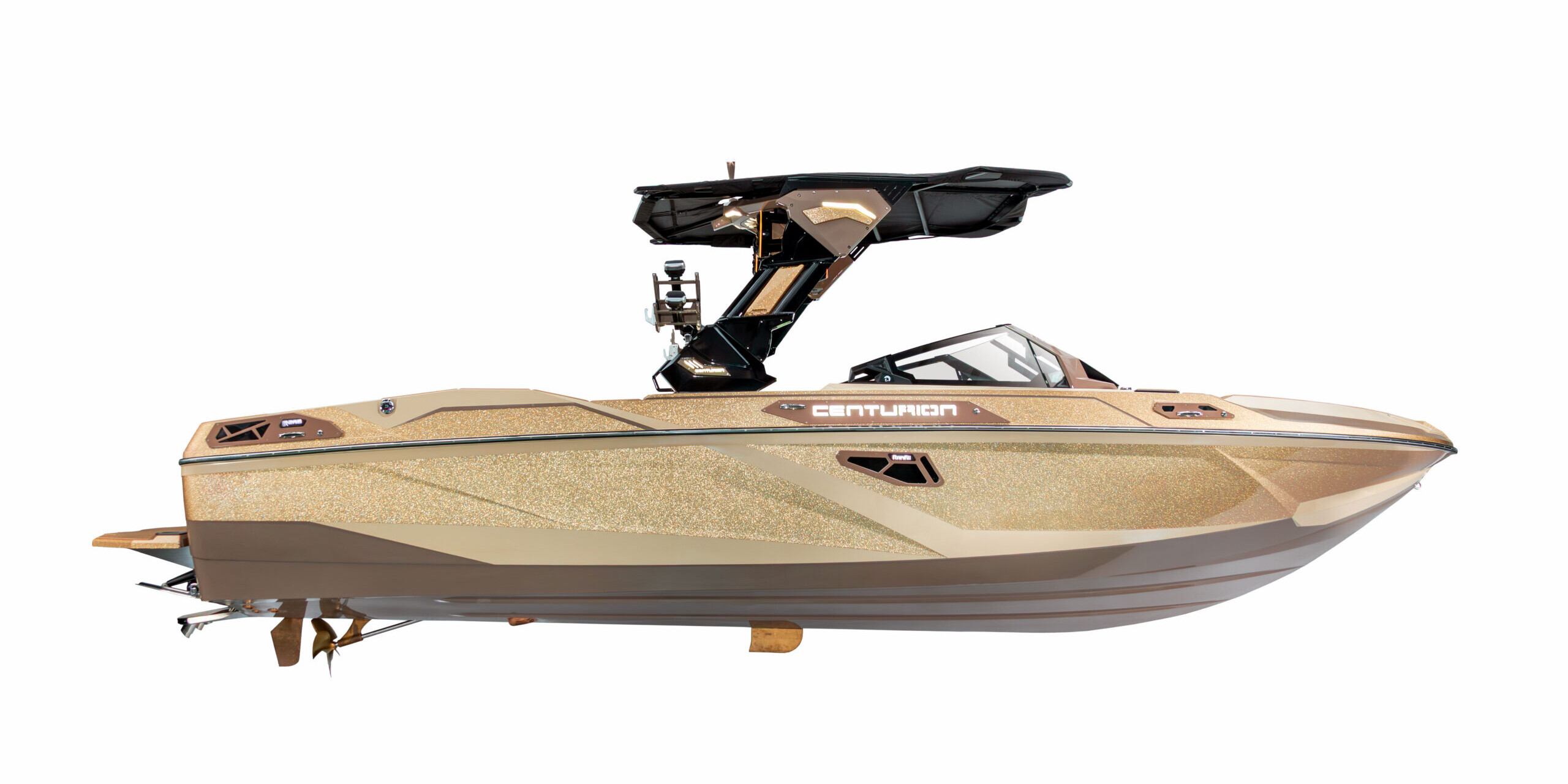 A gold Centurion Ri Series motorboat with a black wakeboard tower, viewed from the side against a white background.