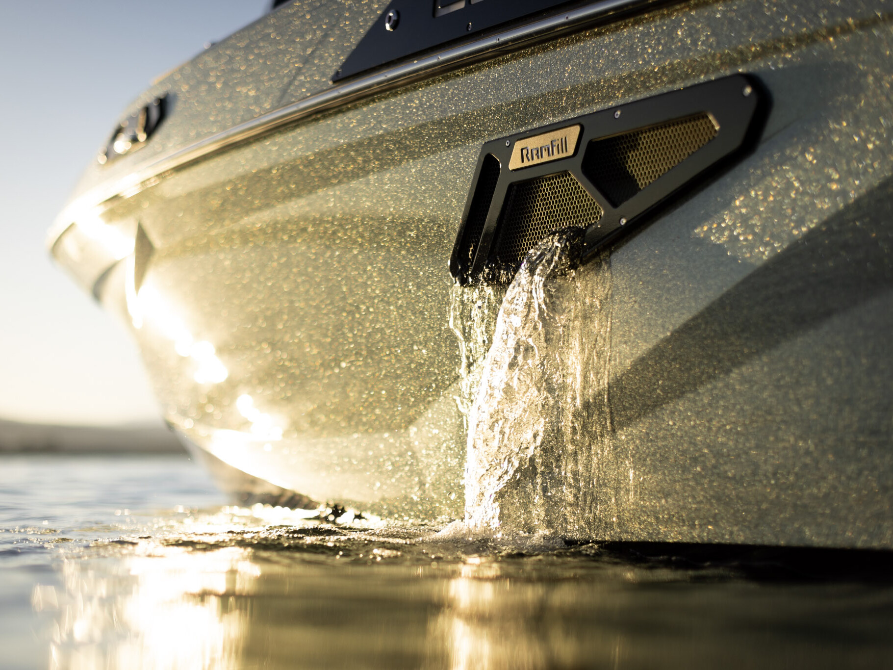 Close-up of water pouring out of a Centurion Ri Series boat’s ballast vent labeled